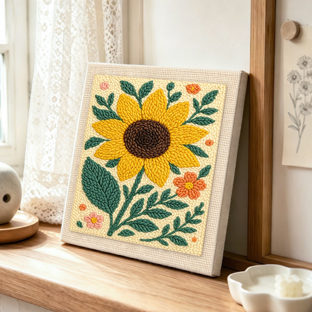 A large sunflower punch needle artwork displayed on a table