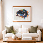 Finished abstract colorful dripping eye cross stitch artwork displayed as home decor