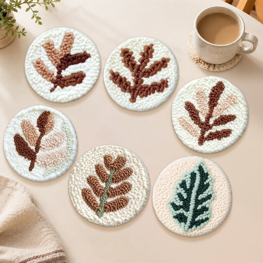 Abstract fern and leaf punch needle coasters used for home decoration