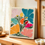 Abstract multicolor fan flowers punch needle artwork displayed on a table
