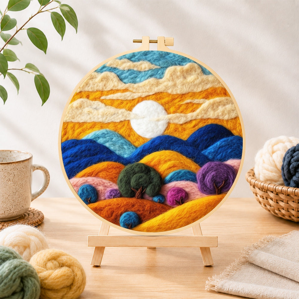 Finished abstract wavy clouds and colorful hills needle felting displayed on a wooden easel