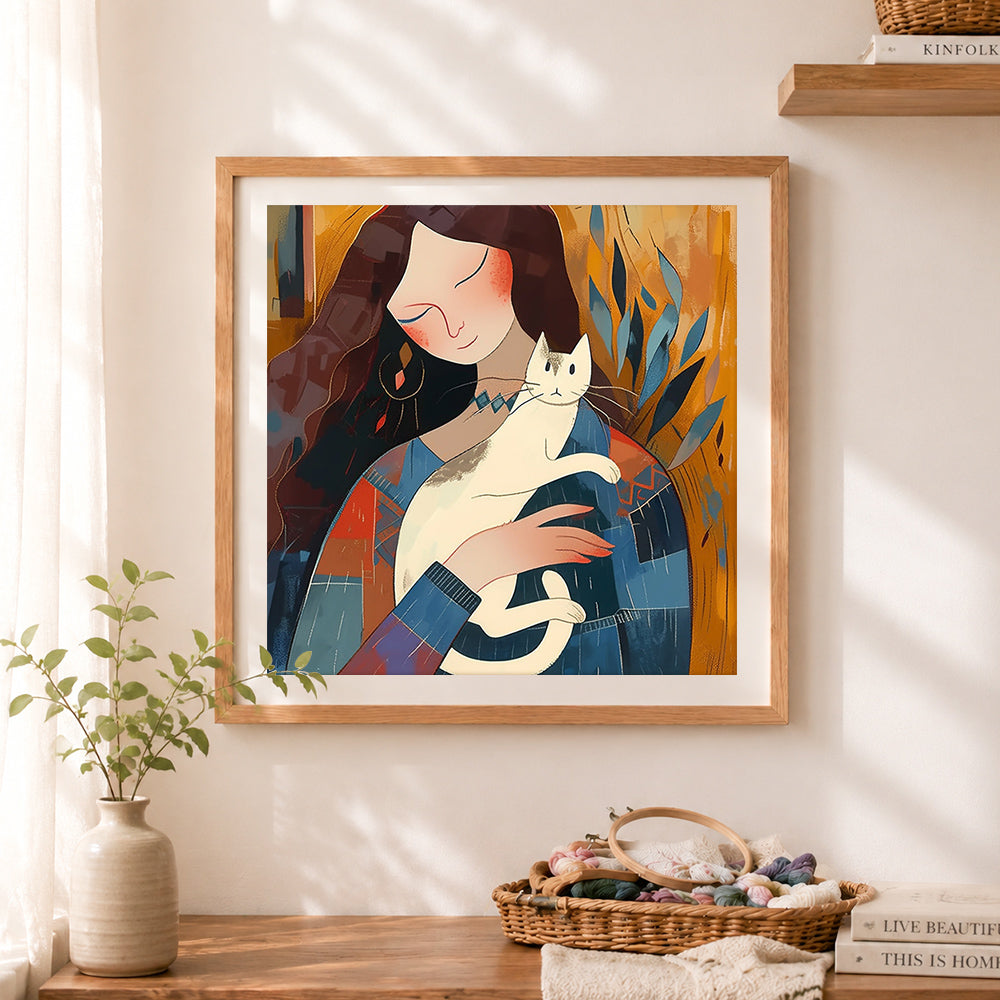 Finished abstract woman holding white cat cross stitch artwork displayed as home decor