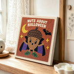Acorn vampire halloween character punch needle artwork displayed on a table