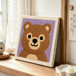Adorable bear face punch needle artwork displayed on a table