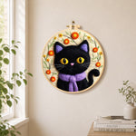 Adorable black cat with scarf needle felt wall art displayed in a bright home interior