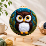 Finished adorable brown and white owl needle felting displayed on a wooden easel