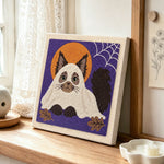 Adorable cat in ghost costume punch needle artwork displayed on a table
