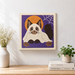 Finished adorable cat in ghost costume artwork displayed on a wall