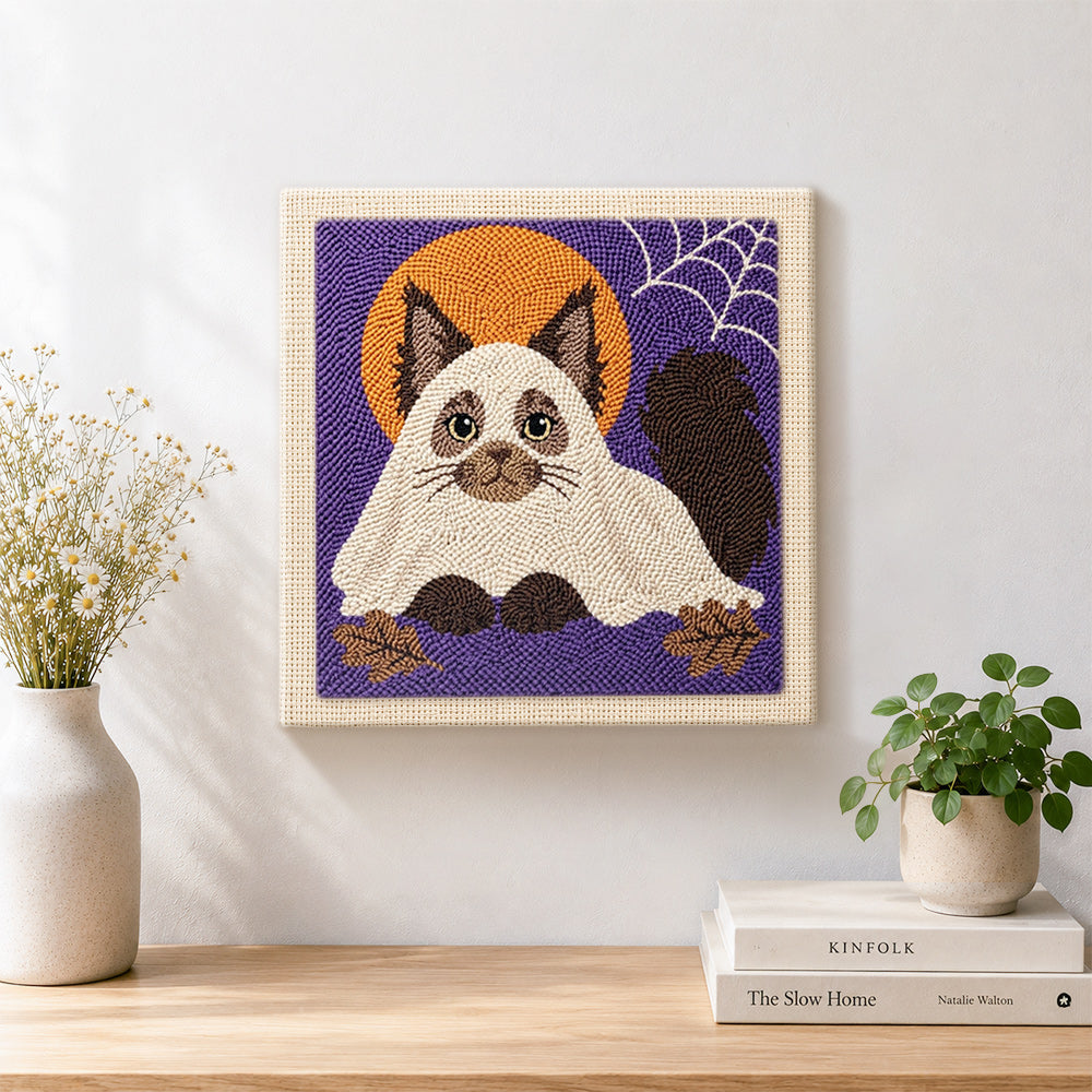 Finished adorable cat in ghost costume artwork displayed on a wall