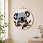 Adorable fluffy koala needle felt wall art displayed in a bright home interior