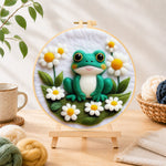Finished adorable frog with white daisies needle felting displayed on a wooden easel