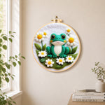 Adorable frog with white daisies needle felt wall art displayed in a bright home interior