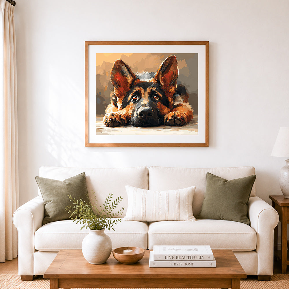 Finished adorable german shepherd puppy laying down cross stitch artwork displayed as home decor
