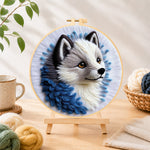Finished adorable gray wolf needle felting displayed on a wooden easel