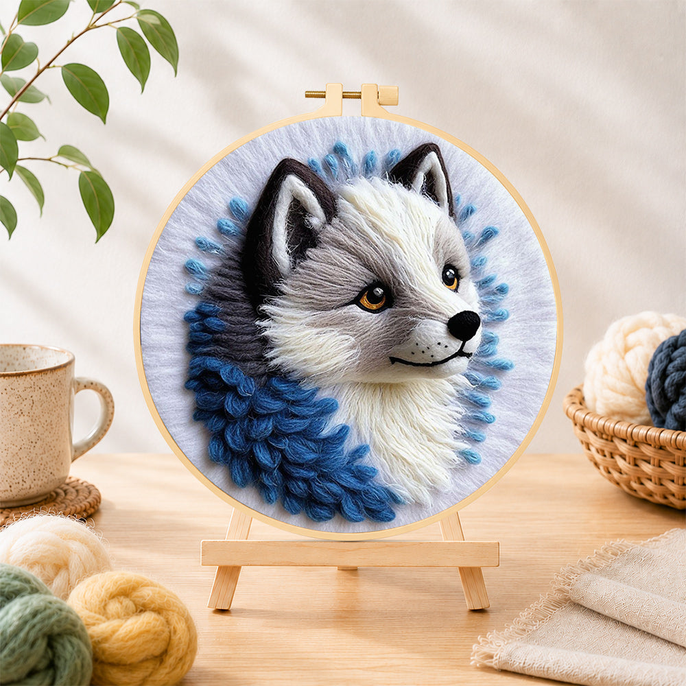 Finished adorable gray wolf needle felting displayed on a wooden easel