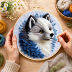 Creating the adorable gray wolf wool painting by hand with a felting needle