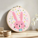 Adorable pink bunny punch needle artwork displayed on a table
