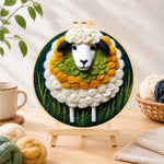 Finished adorable sheep and green grass needle felting displayed on a wooden easel