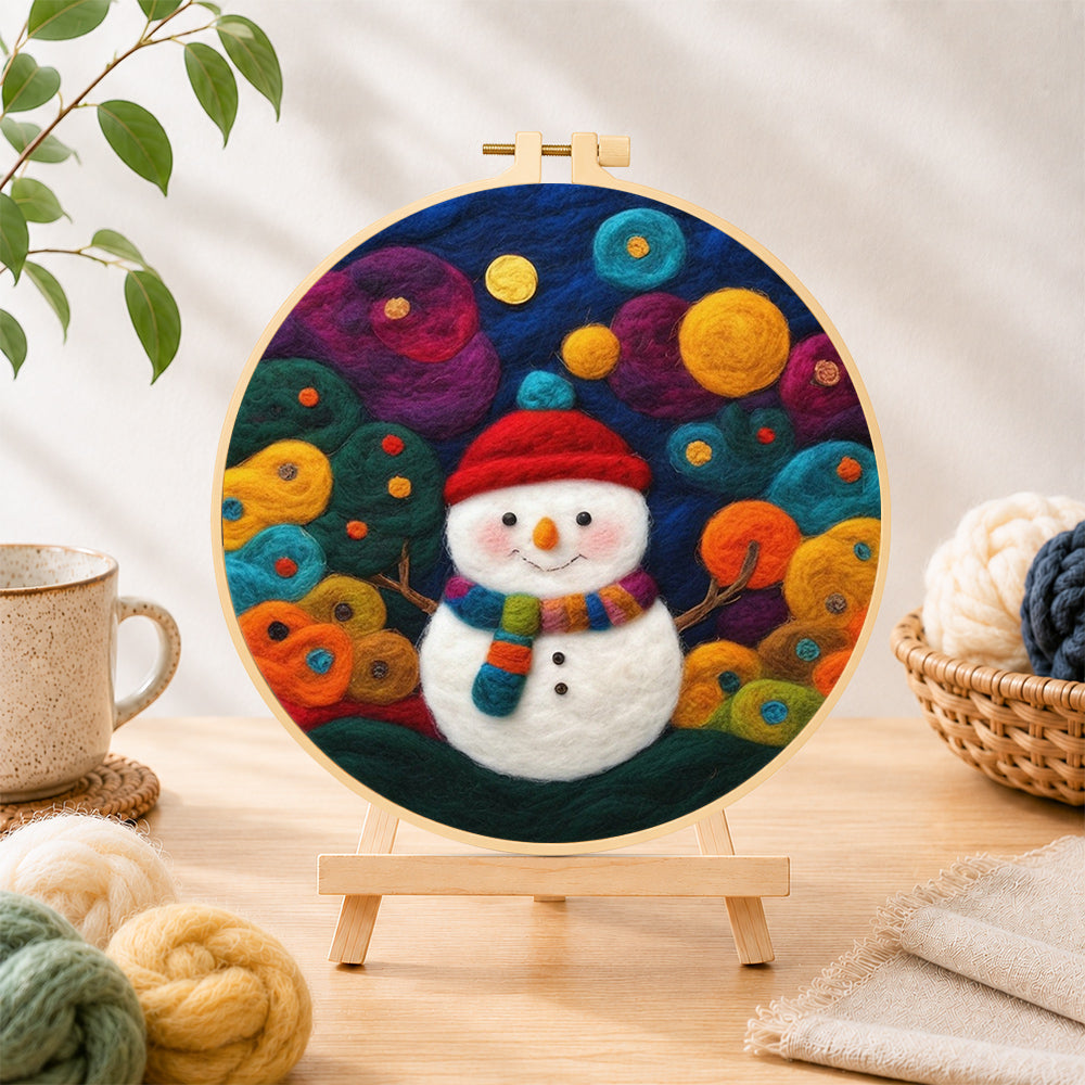 Finished adorable snowman with scarf needle felting displayed on a wooden easel