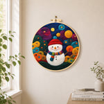 Adorable snowman with scarf needle felt wall art displayed in a bright home interior