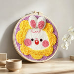 Adorable sunflower bunny punch needle artwork displayed on a table