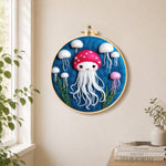 Adorable white jellyfish needle felt wall art displayed in a bright home interior