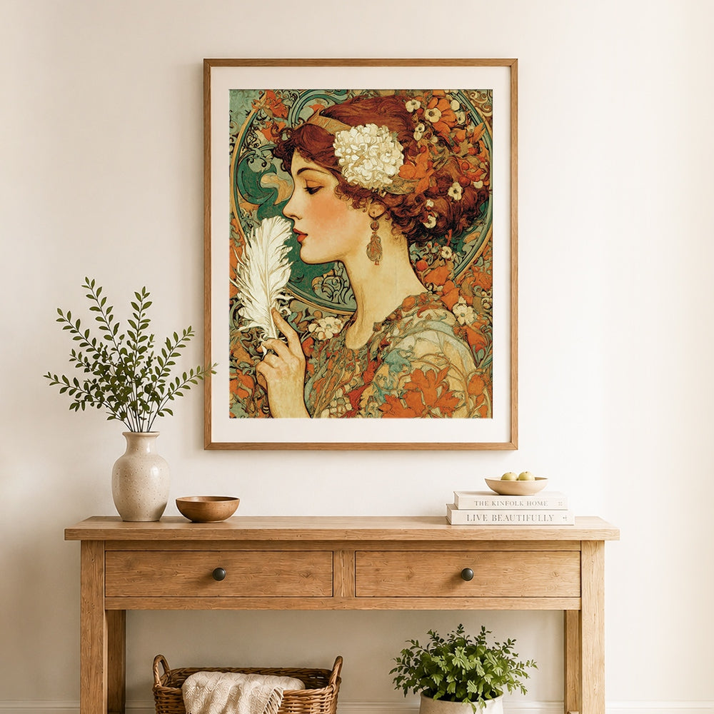 Finished art nouveau woman holding feather cross stitch artwork displayed as home decor