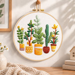 Assorted houseplants embroidery hoop wall art displayed as warm and cozy handmade home decor