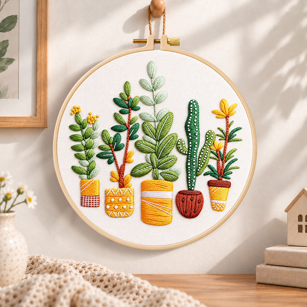 Assorted houseplants embroidery hoop wall art displayed as warm and cozy handmade home decor