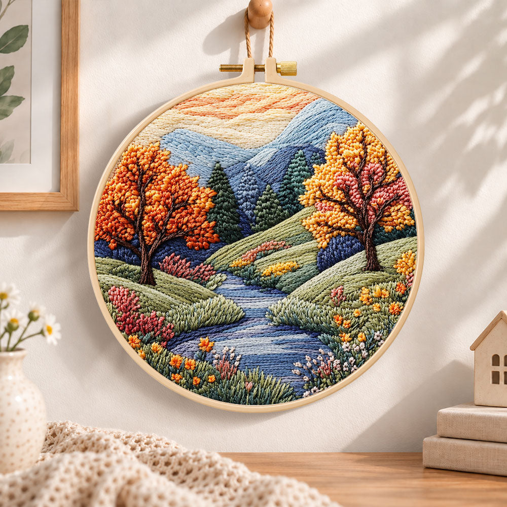 Autumn creek and trees embroidery hoop wall art displayed as warm and cozy handmade home decor