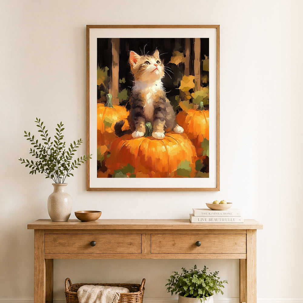 Finished autumn kitten on pumpkin cross stitch artwork displayed as home decor