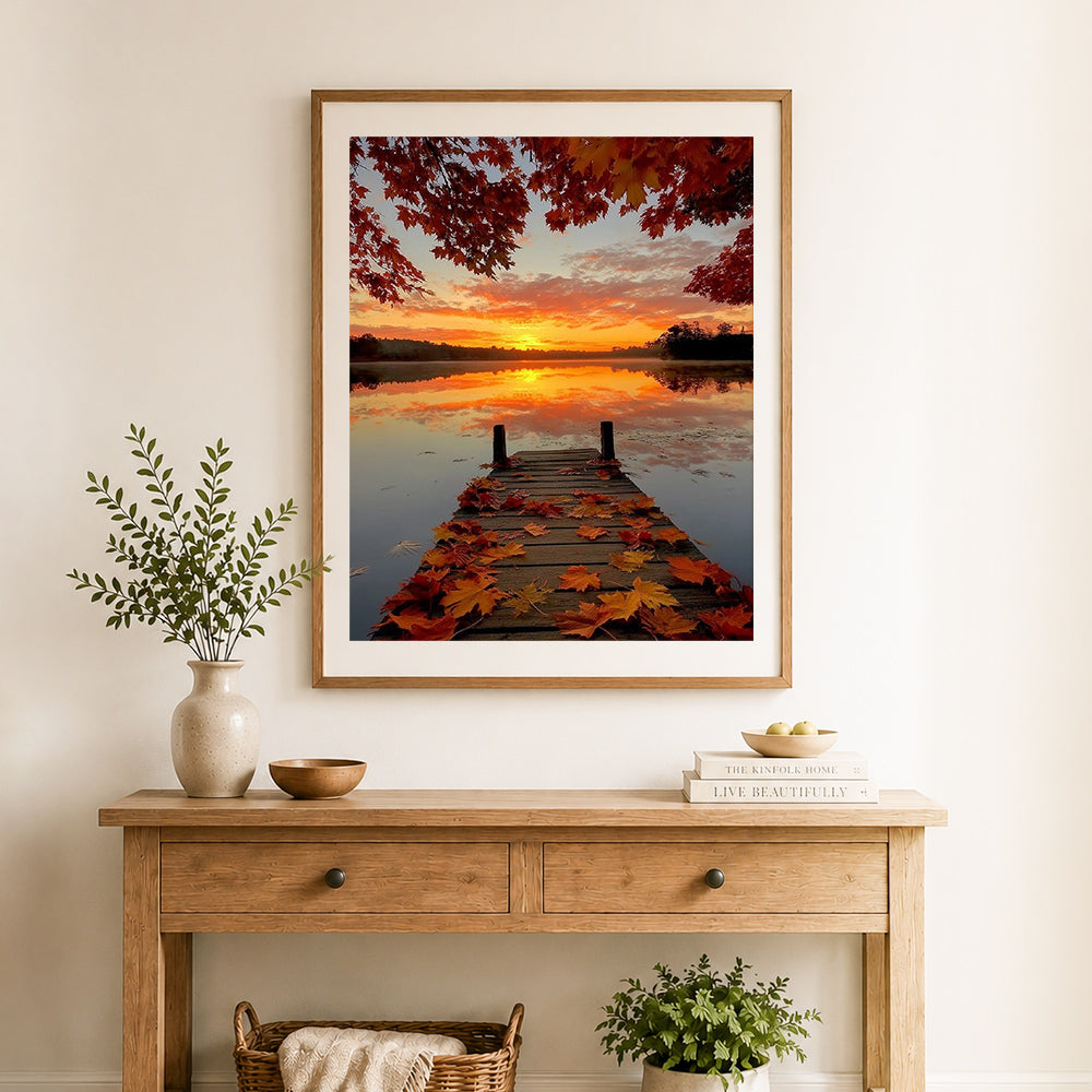 Finished autumn lake sunrise cross stitch artwork displayed as home decor