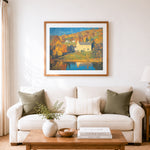 Finished autumn lakeside cottage cross stitch artwork displayed as home decor