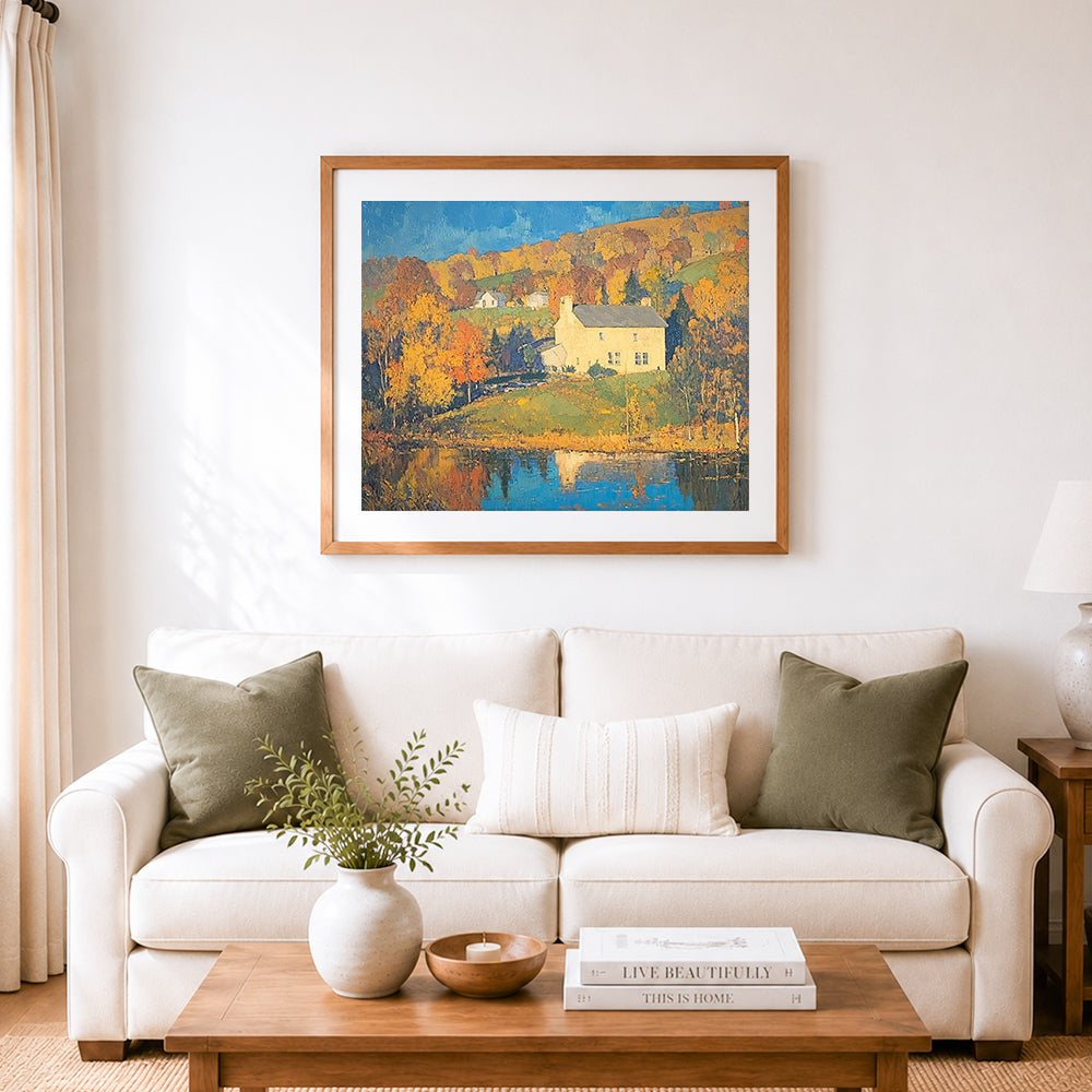 Finished autumn lakeside cottage cross stitch artwork displayed as home decor