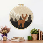 Finished autumn mountains and deer artwork displayed on a wall