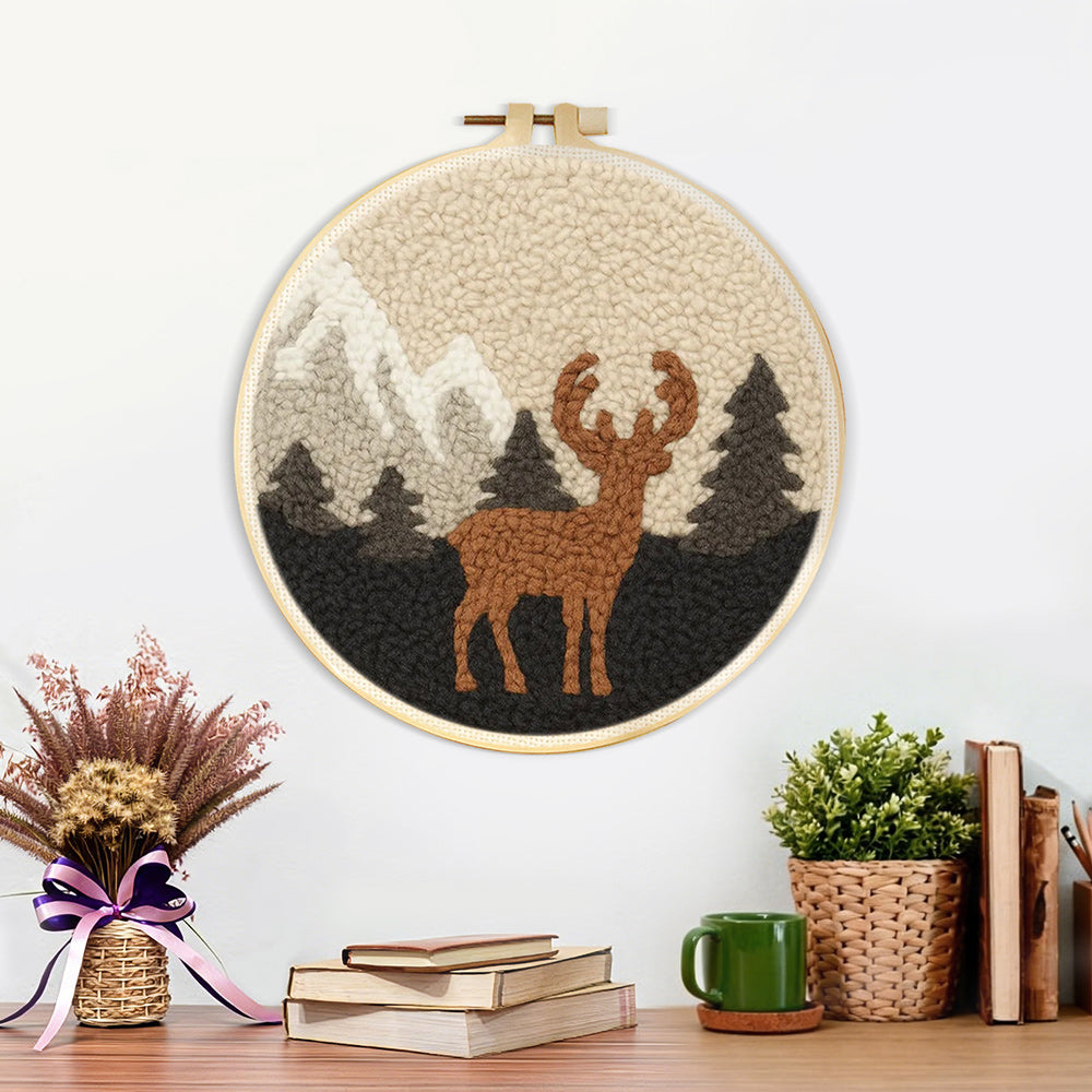Finished autumn mountains and deer artwork displayed on a wall