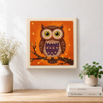 Finished autumn owl embroidery art artwork displayed on a wall