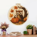 Finished autumn pumpkin and owl artwork displayed on a wall
