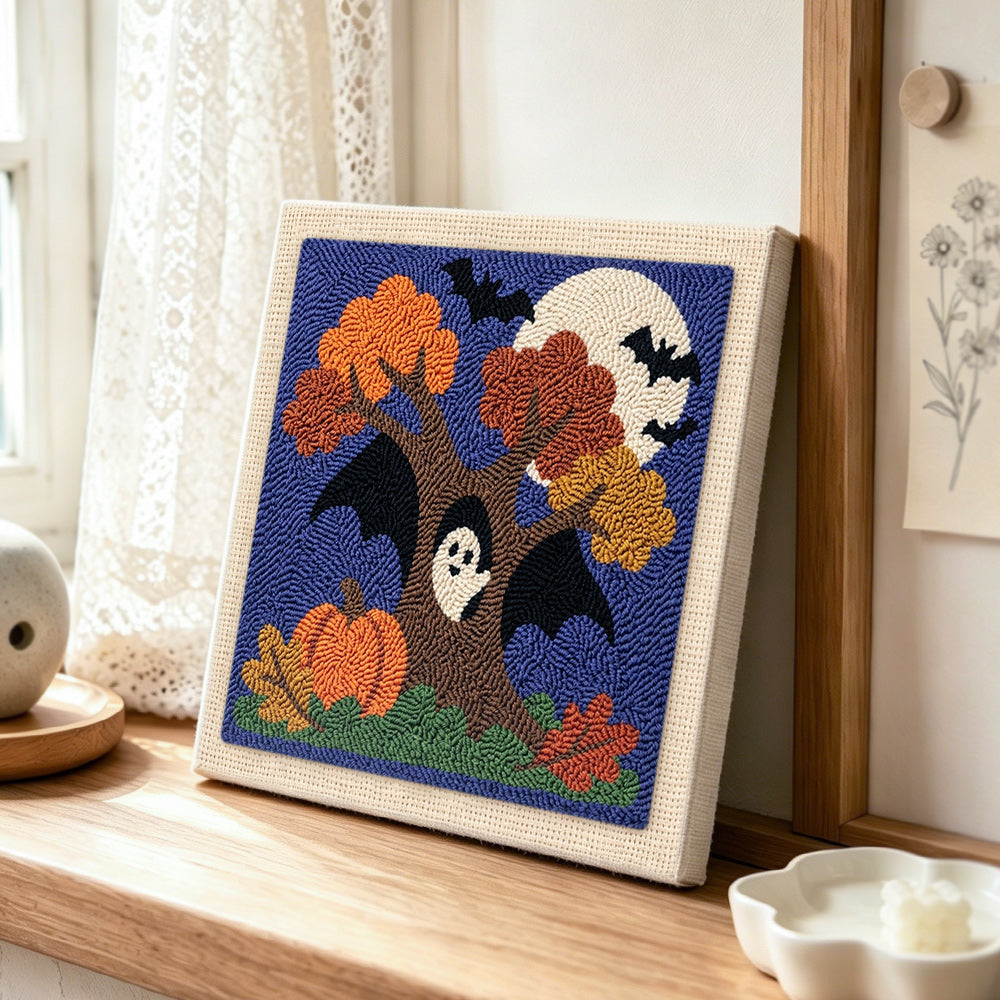 Autumn tree ghost punch needle artwork displayed on a table