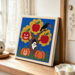 Autumn tree ghost scene punch needle artwork displayed on a table