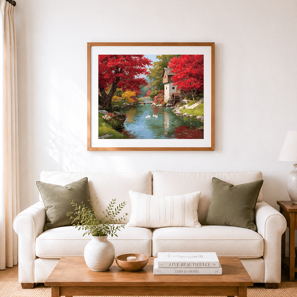 Finished autumn watermill cottage cross stitch artwork displayed as home decor