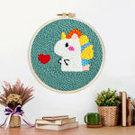 Finished baby dinosaur and red heart artwork displayed on a wall