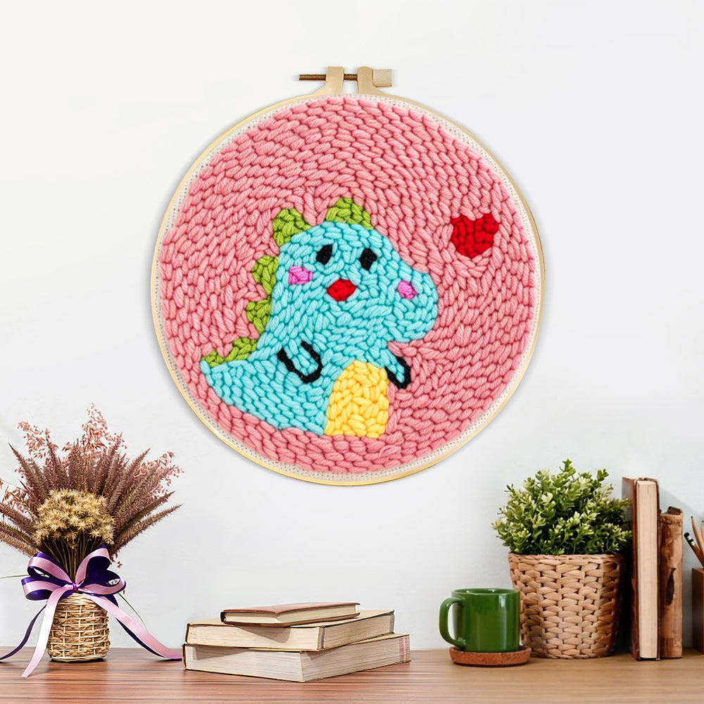 Finished baby dinosaur and little heart artwork displayed on a wall
