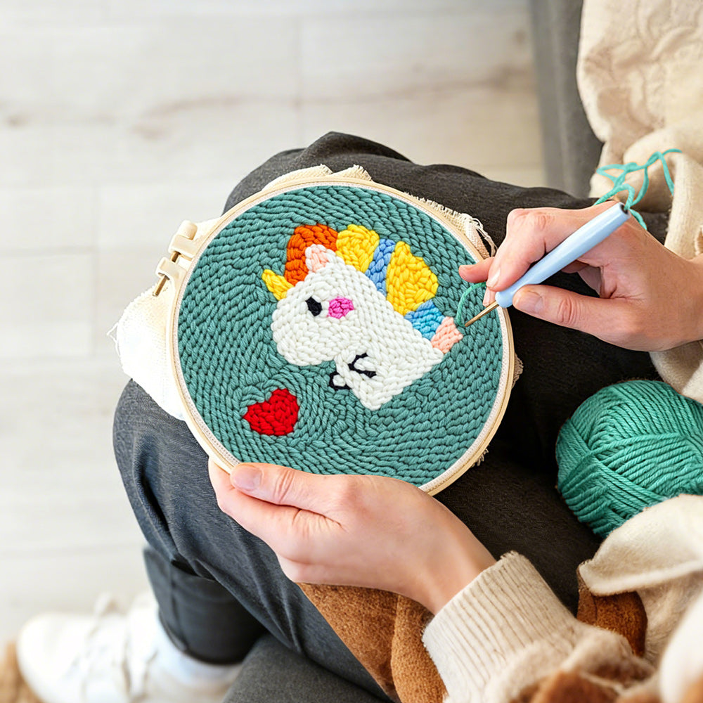 Creating handmade baby dinosaur and red heart punch needle artwork
