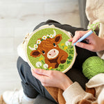 Creating handmade baby highland cow and dandelions punch needle artwork