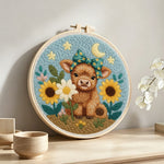 Baby highland cow and sunflowers punch needle artwork displayed on a table