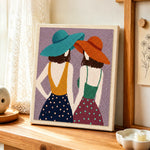 Back view women in hats punch needle artwork displayed on a table