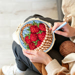 Creating handmade basket of fresh strawberries punch needle artwork