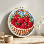 Basket of fresh strawberries punch needle artwork displayed on a table