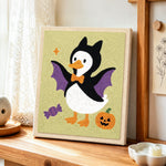 Bat costume duck punch needle artwork displayed on a table